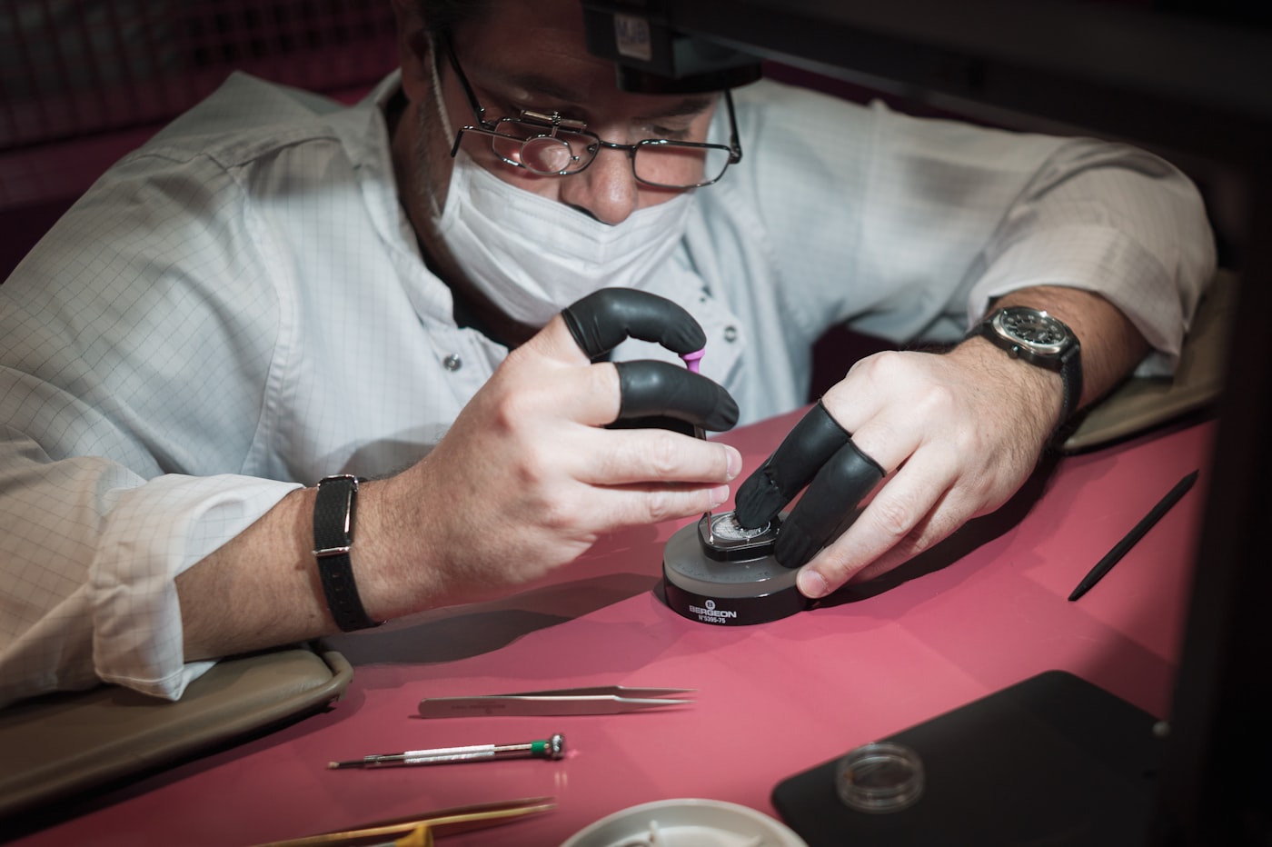 Watchmaker servicing a timepiece